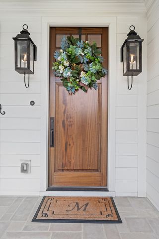a living room with furniture and floor to ceiling windows