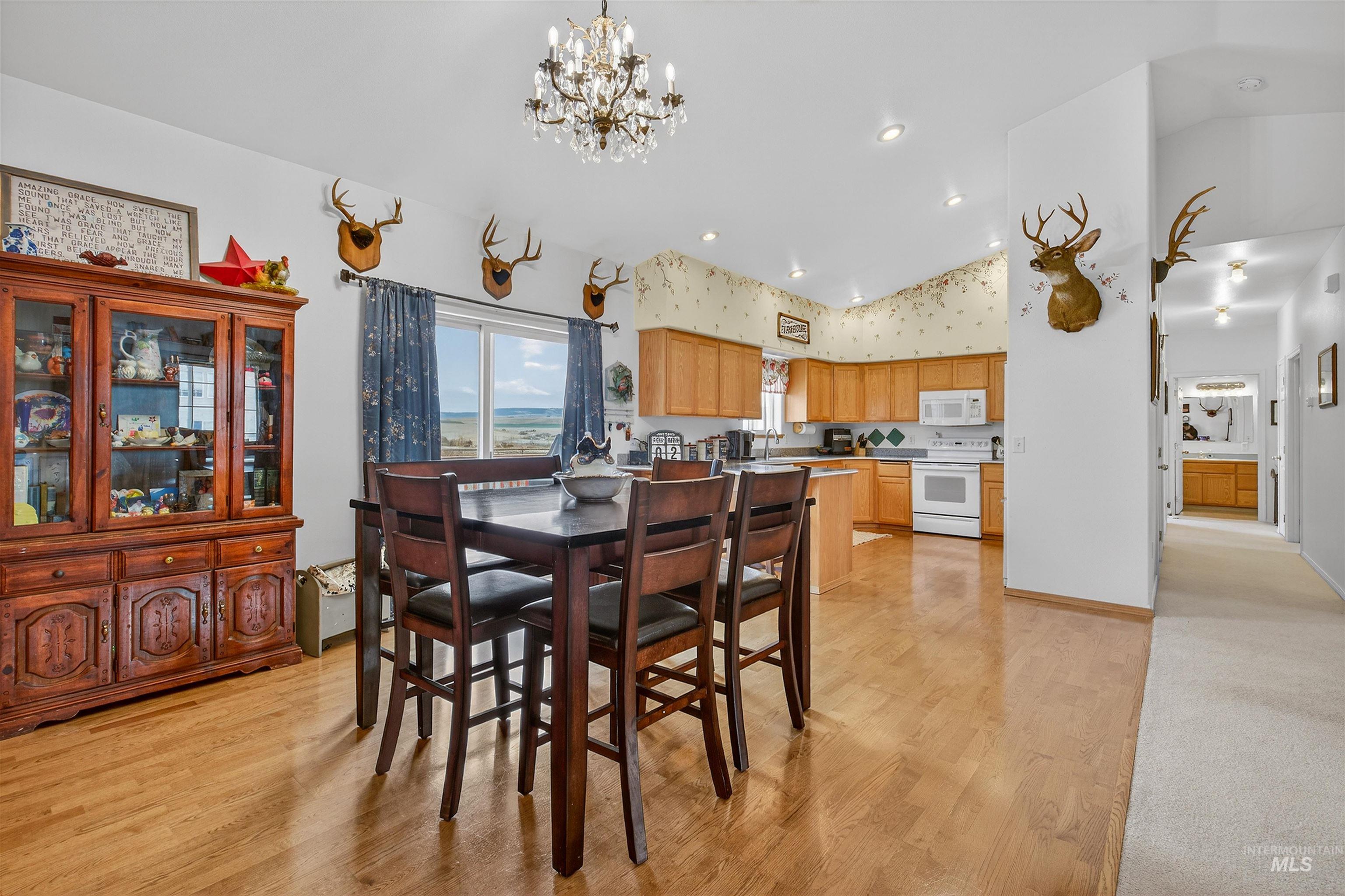 3737 19th Street Lewiston, ID 83501 - Photo 11 of 40 Dining room featuring lofted ceiling, a chandelier, and light wood-style floors