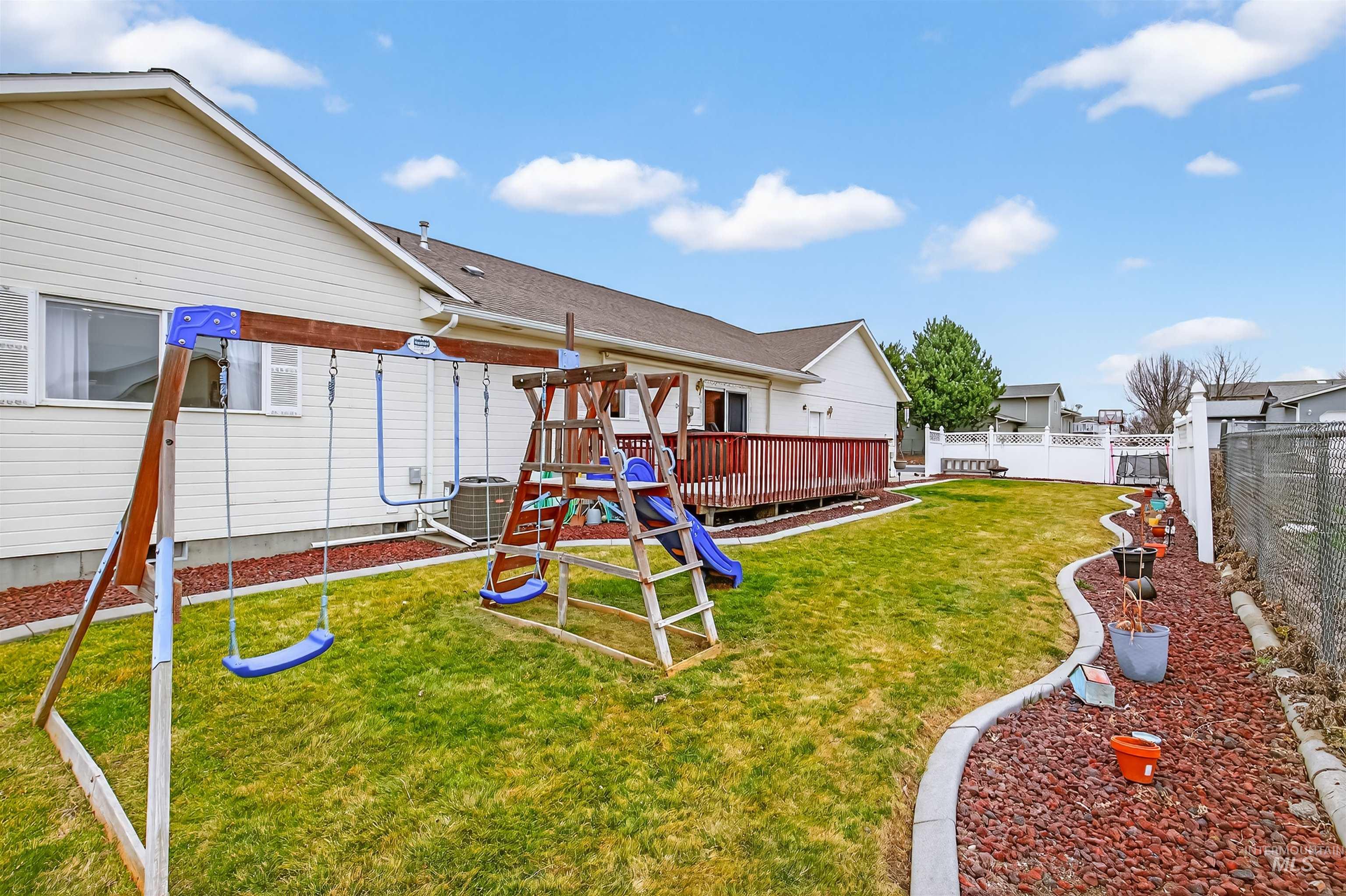 3737 19th Street Lewiston, ID 83501 - Photo 32 of 40 Back of house featuring a playground, a wooden deck, and a fenced backyard