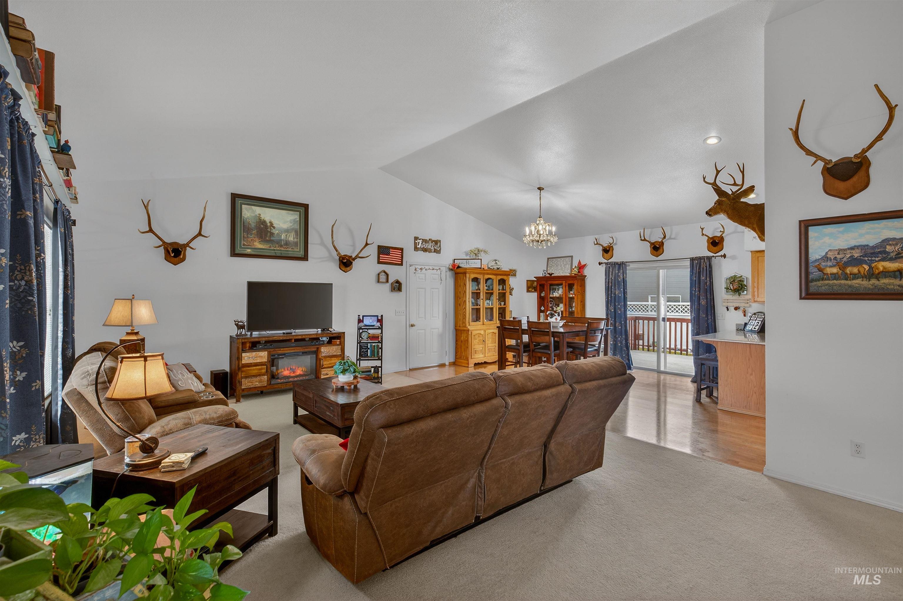 3737 19th Street Lewiston, ID 83501 - Photo 6 of 40 Carpeted living room featuring vaulted ceiling and hanging lights