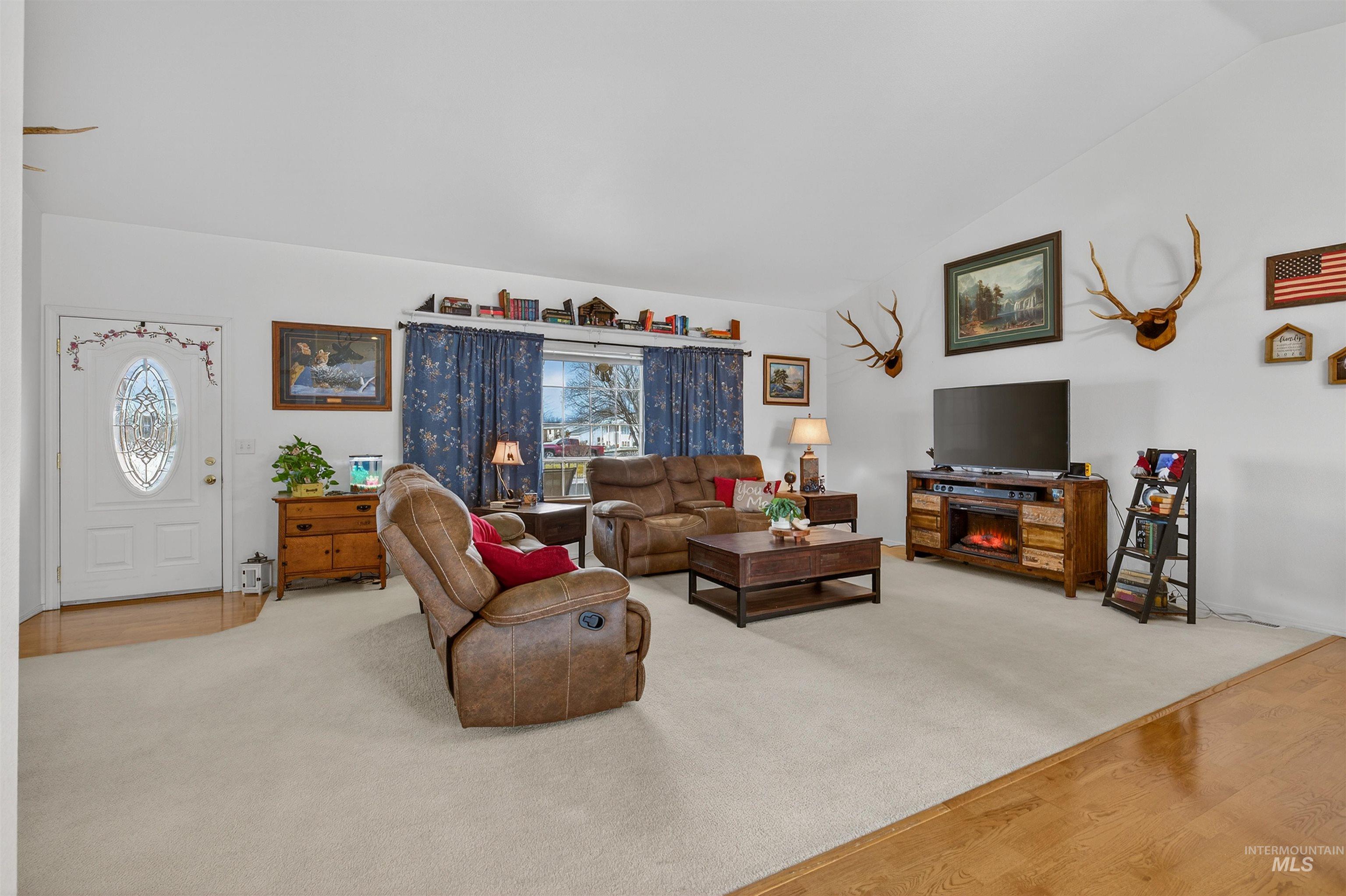 3737 19th Street Lewiston, ID 83501 - Photo 8 of 40 Carpeted living room featuring vaulted ceiling and wood finished floors