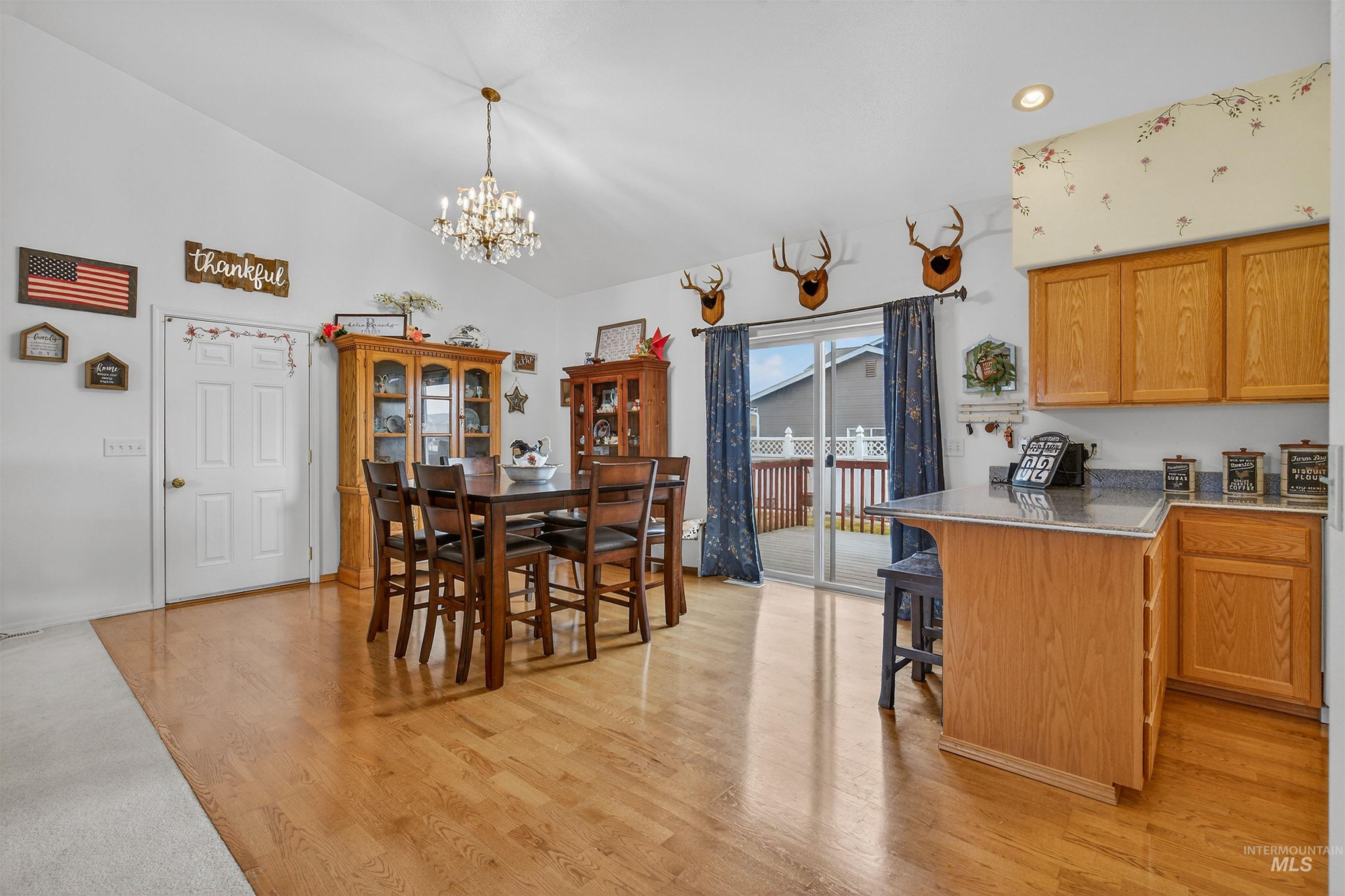 3737 19th Street Lewiston, ID 83501 - Photo 9 of 40 Kitchen featuring a breakfast bar, light wood-style floors, a peninsula, light stone counters, and suspended lighting