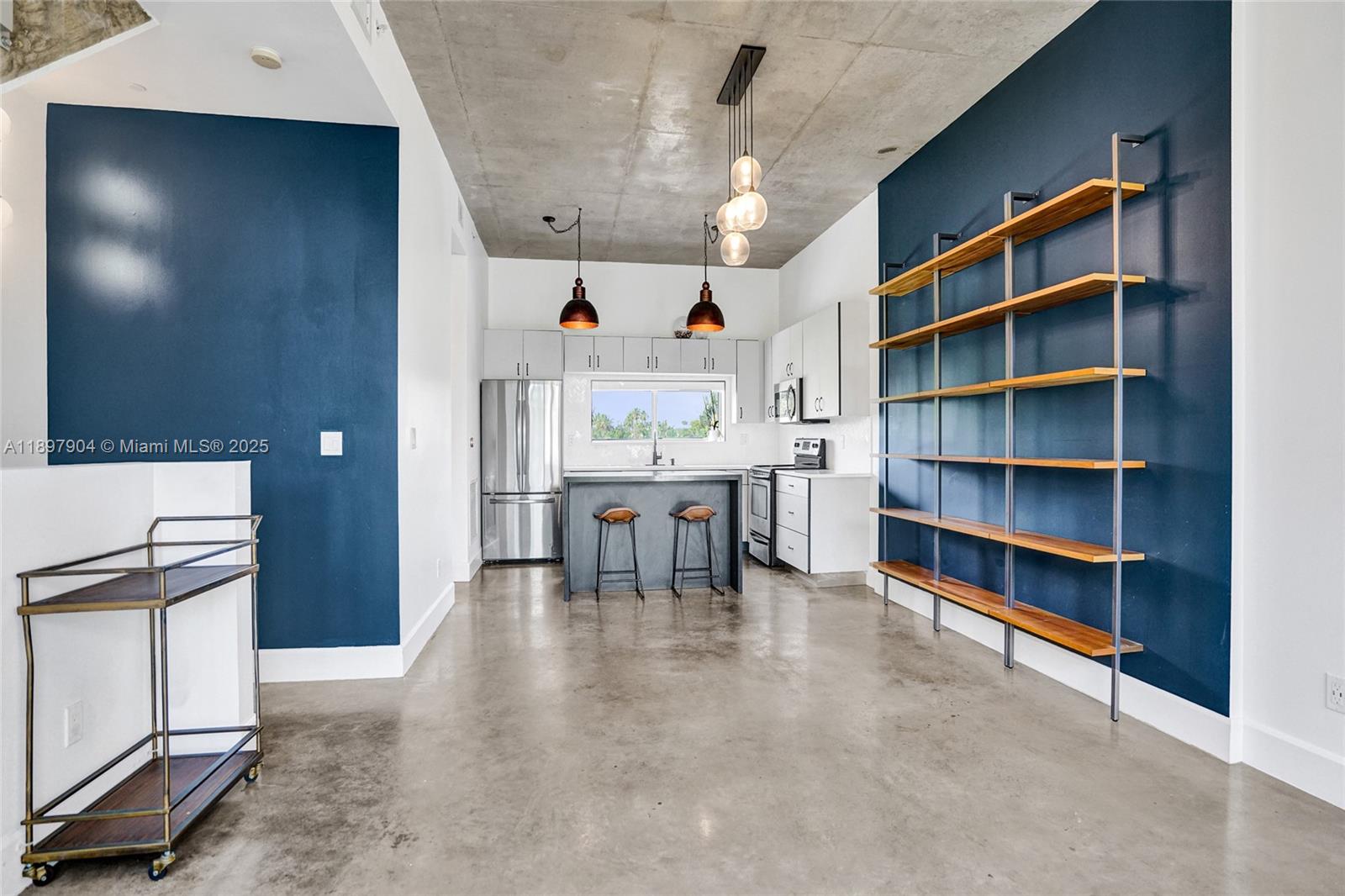 716 Southeast 12th Street, Unit 13 Fort Lauderdale, FL 33316 - Photo 11 of 45 a view of a kitchen with furniture and a book shelf