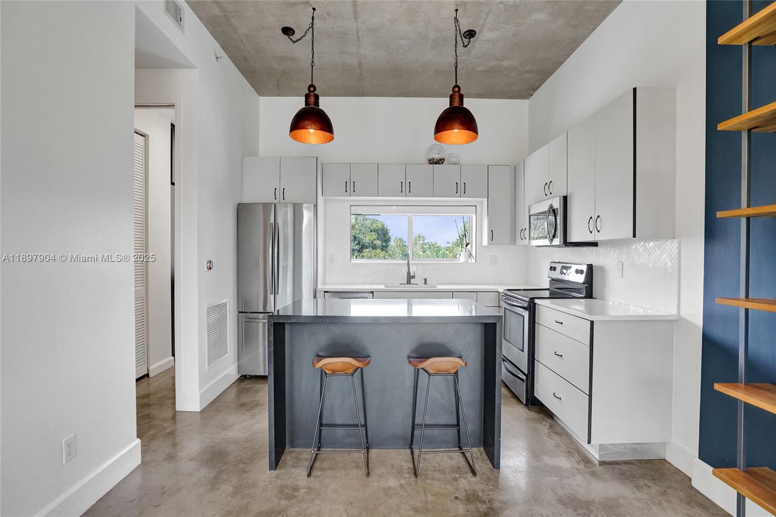 716 Southeast 12th Street, Unit 13 Fort Lauderdale, FL 33316 - Photo 14 of 45 a kitchen with stainless steel appliances granite countertop a sink and a refrigerator