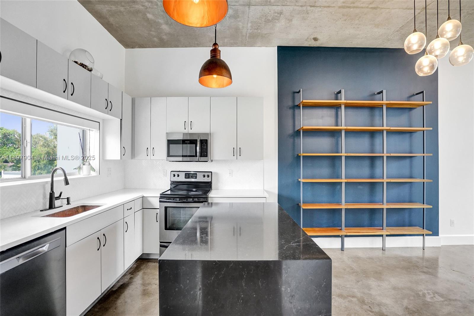716 Southeast 12th Street, Unit 13 Fort Lauderdale, FL 33316 - Photo 15 of 45 a kitchen with stainless steel appliances a stove a sink and a microwave