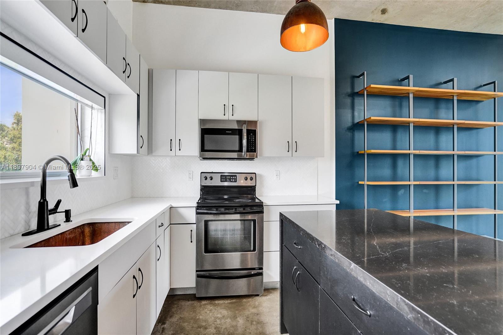 716 Southeast 12th Street, Unit 13 Fort Lauderdale, FL 33316 - Photo 16 of 45 a kitchen with stainless steel appliances granite countertop a sink a stove and a microwave
