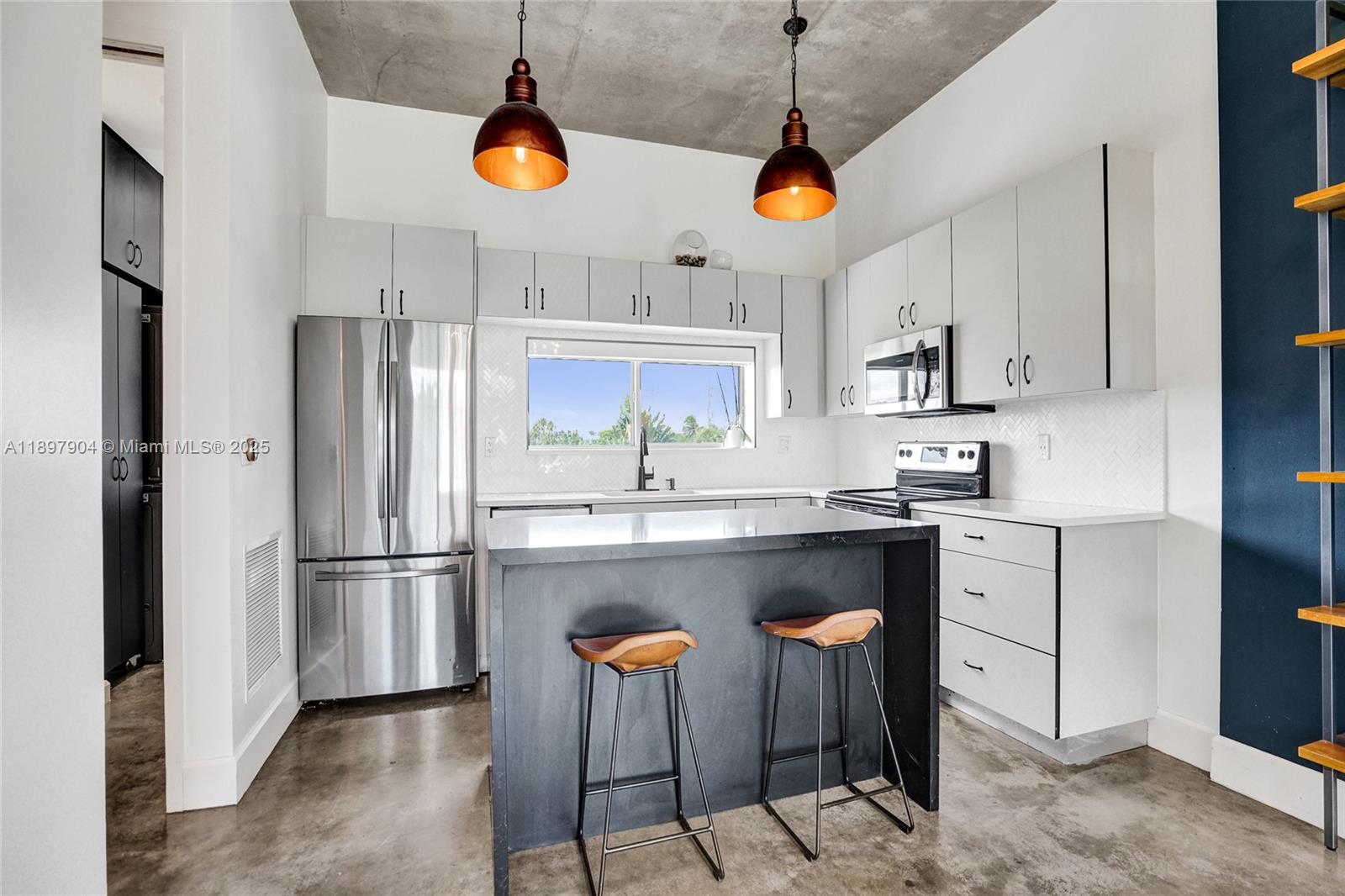 716 Southeast 12th Street, Unit 13 Fort Lauderdale, FL 33316 - Photo 17 of 45 a kitchen with stainless steel appliances granite countertop a refrigerator a sink and a stove