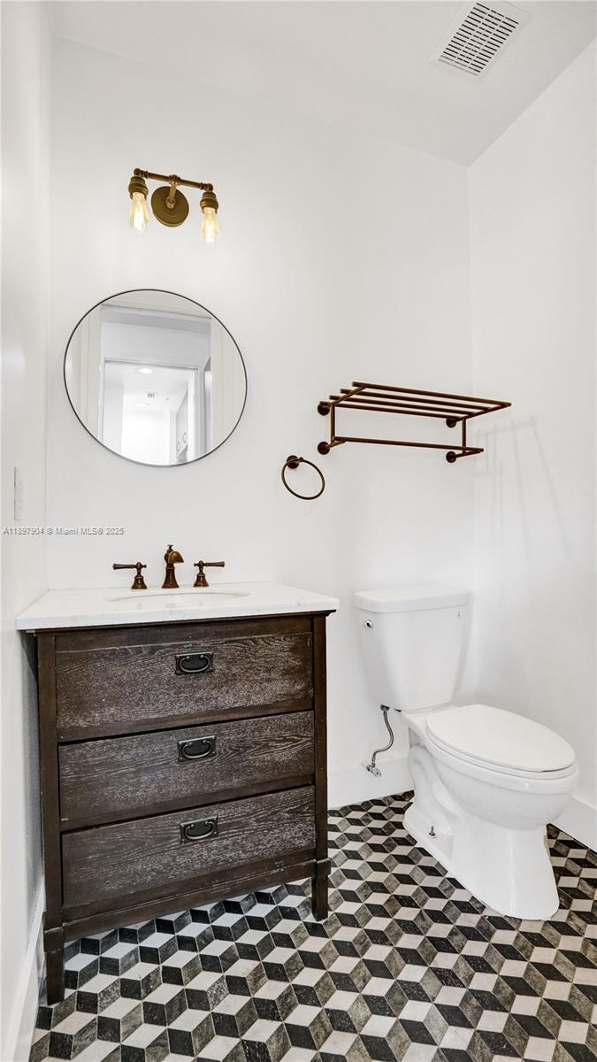 716 Southeast 12th Street, Unit 13 Fort Lauderdale, FL 33316 - Photo 34 of 45 a bathroom with a sink mirror and toilet