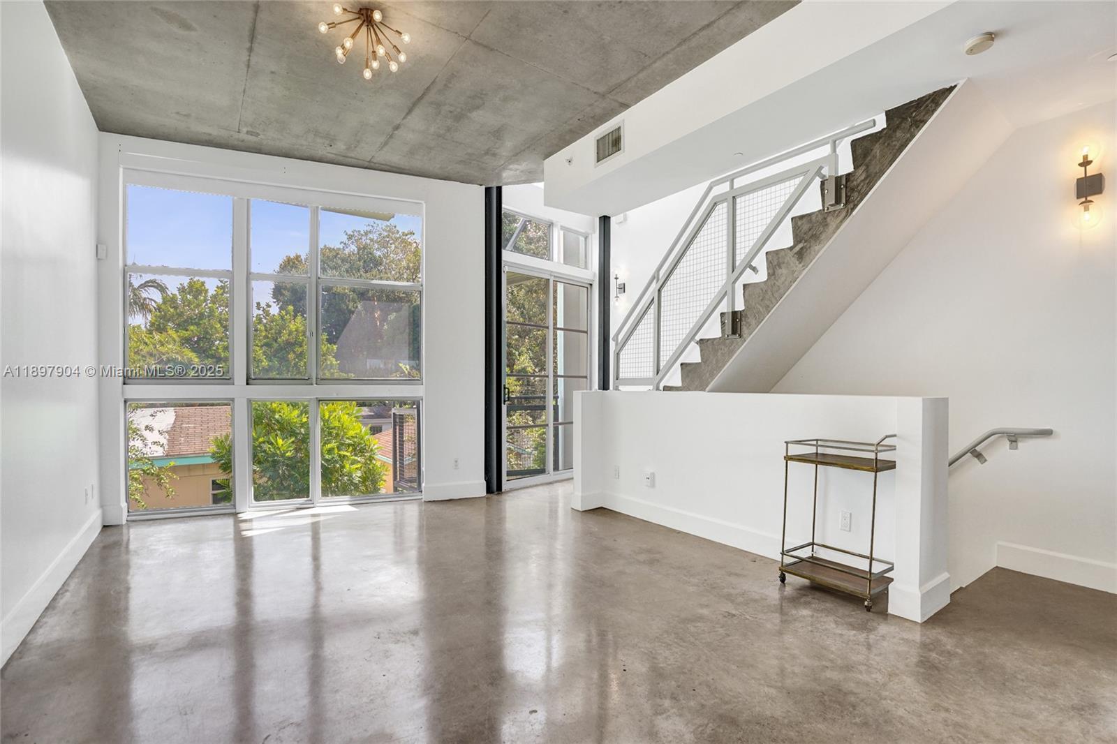 716 Southeast 12th Street, Unit 13 Fort Lauderdale, FL 33316 - Photo 9 of 45 a view of an empty room with wooden floor and a window