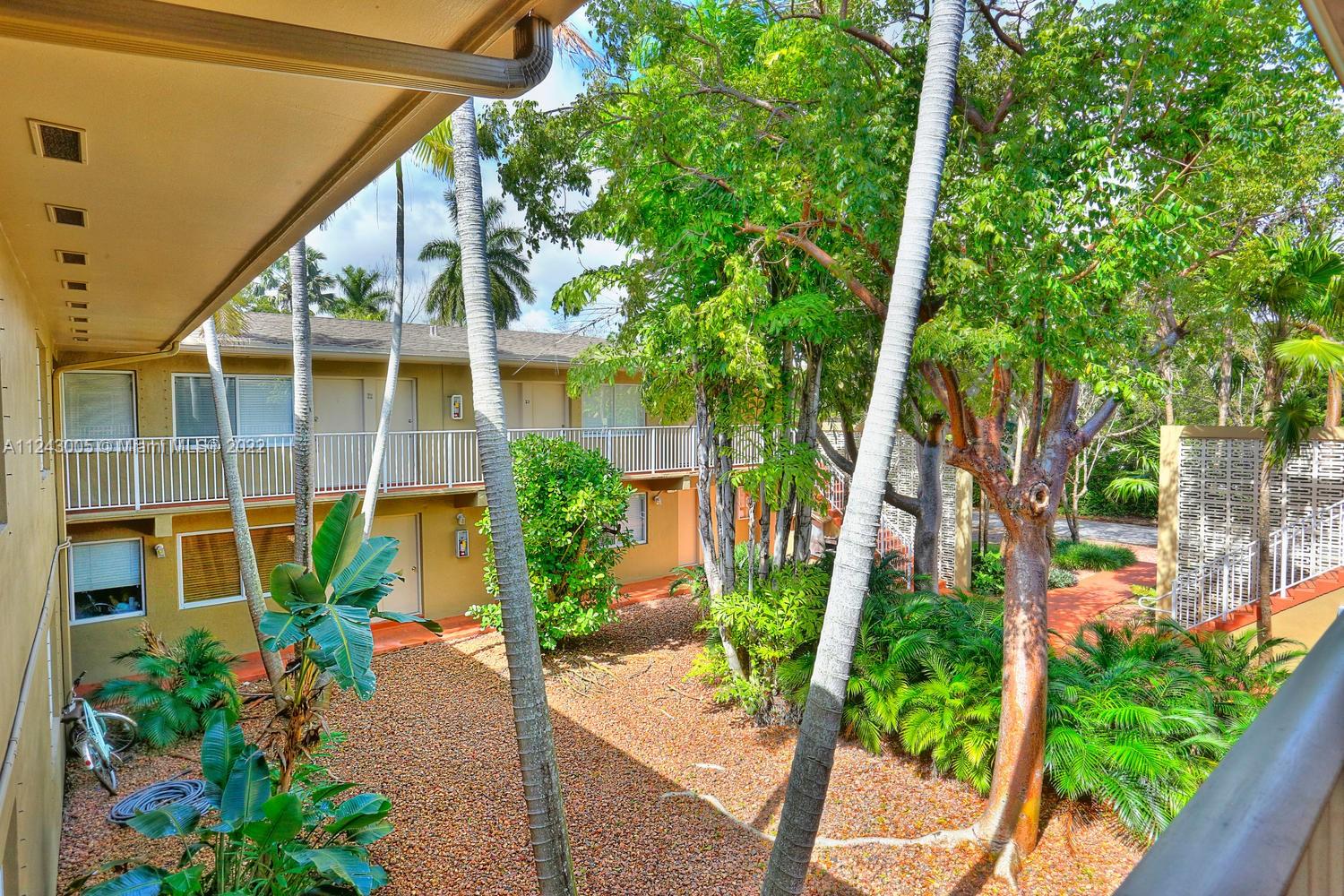 6310 Southwest 79th Street, Unit 18 South Miami, FL 33143 - Photo 13 of 16 a house with a flower garden