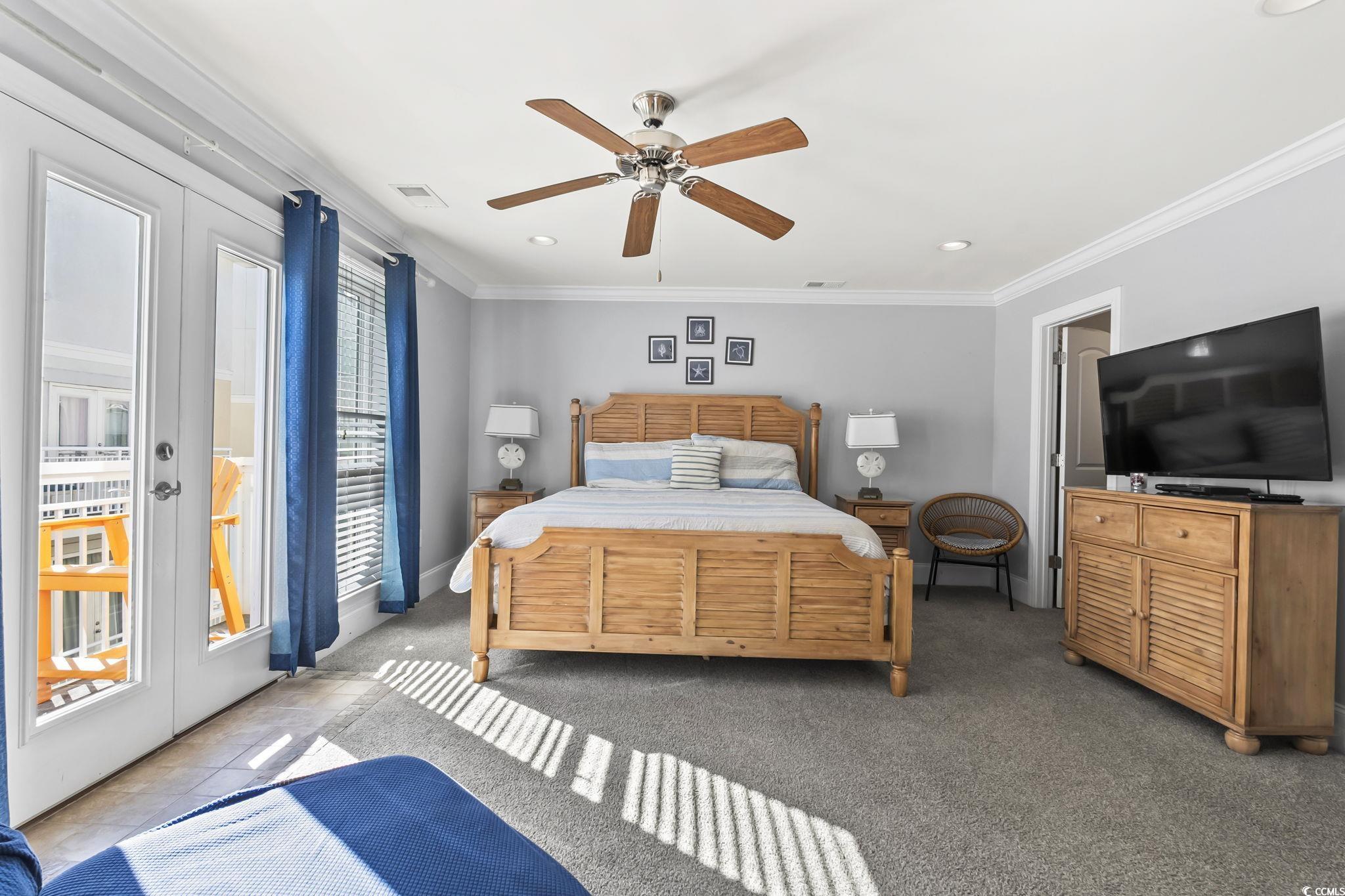 7401 North Ocean Boulevard, Unit 5 Myrtle Beach, SC 29572 - Photo 12 of 34 Bedroom featuring access to outside, ornamental molding, ceiling fan, carpet, and french doors