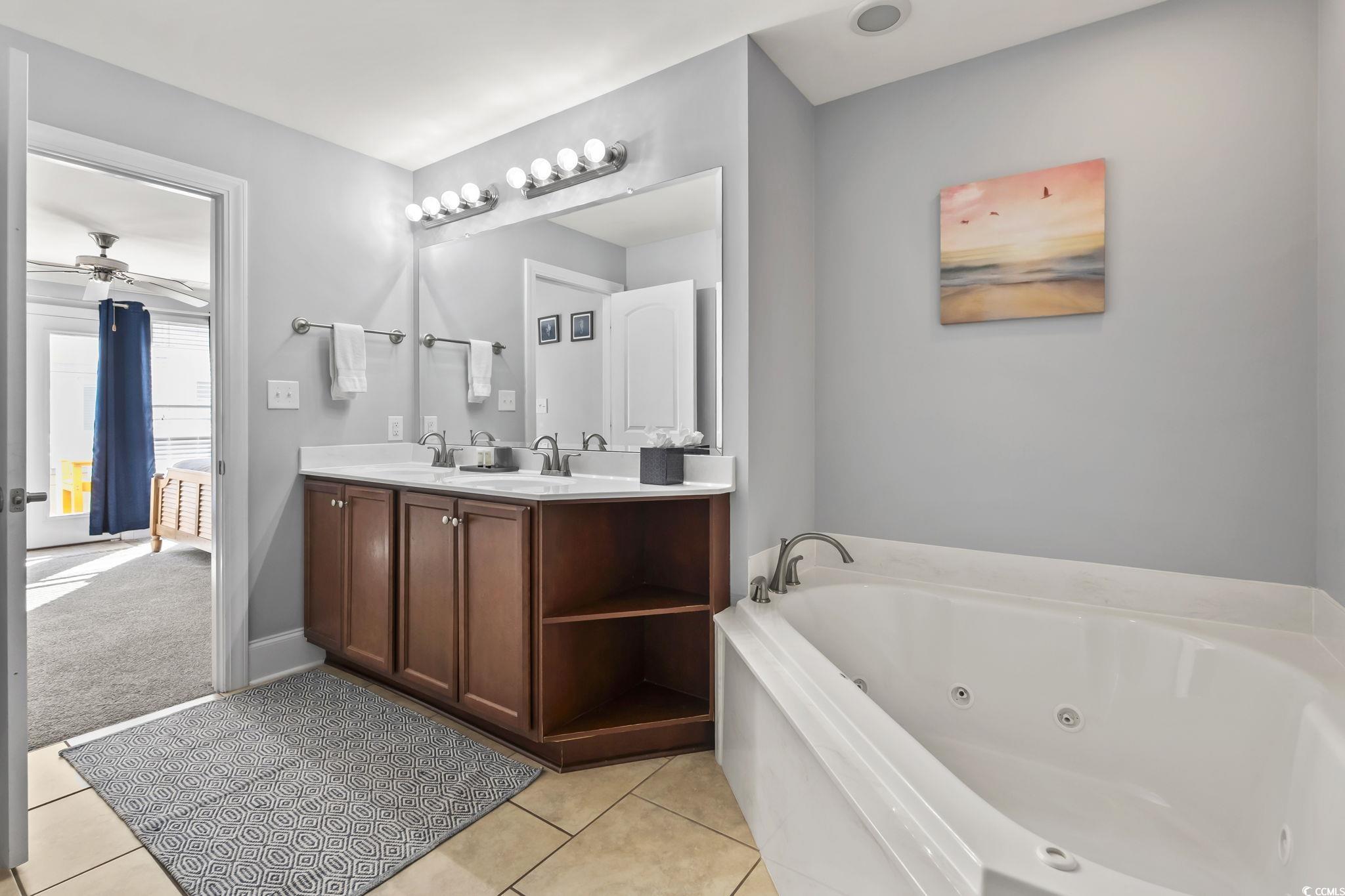 7401 North Ocean Boulevard, Unit 5 Myrtle Beach, SC 29572 - Photo 15 of 34 Full bathroom with a whirlpool tub, double vanity, light tile patterned floors, and ceiling fan
