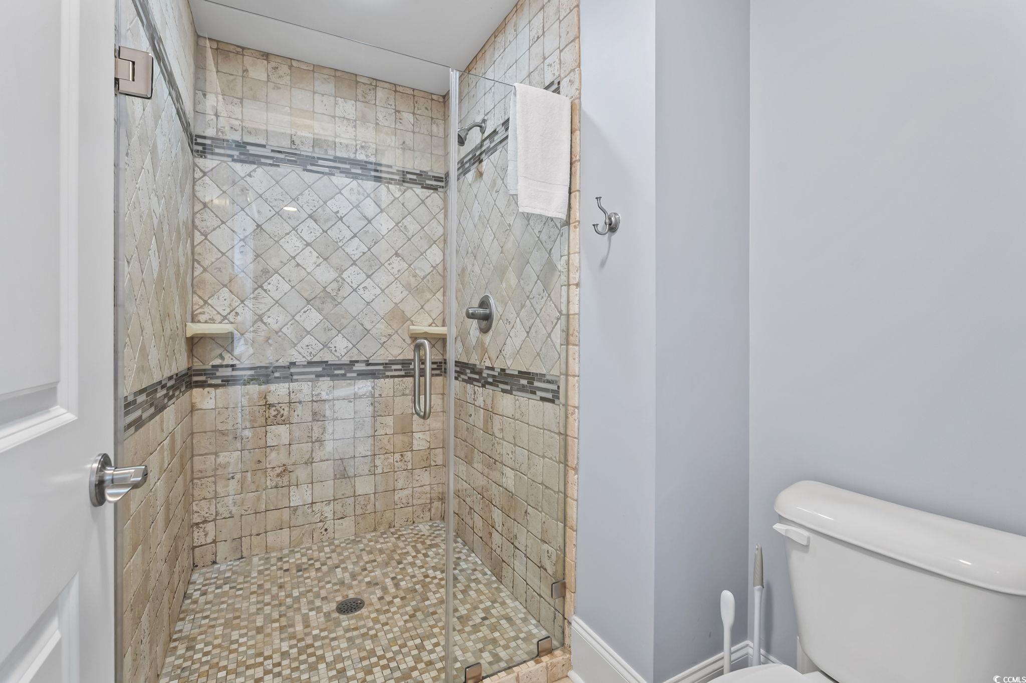 7401 North Ocean Boulevard, Unit 5 Myrtle Beach, SC 29572 - Photo 16 of 34 Bathroom with a stall shower and toilet