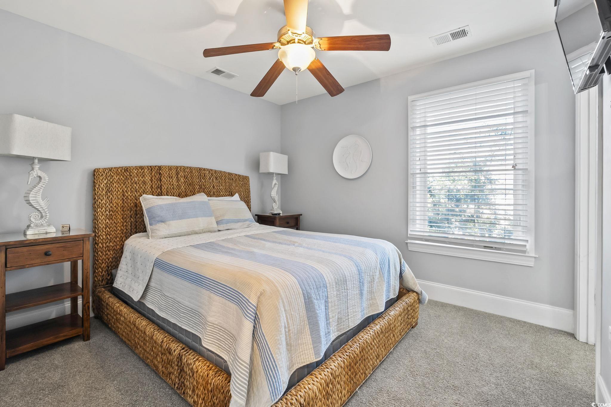 7401 North Ocean Boulevard, Unit 5 Myrtle Beach, SC 29572 - Photo 18 of 34 Bedroom with ceiling fan and carpet floors