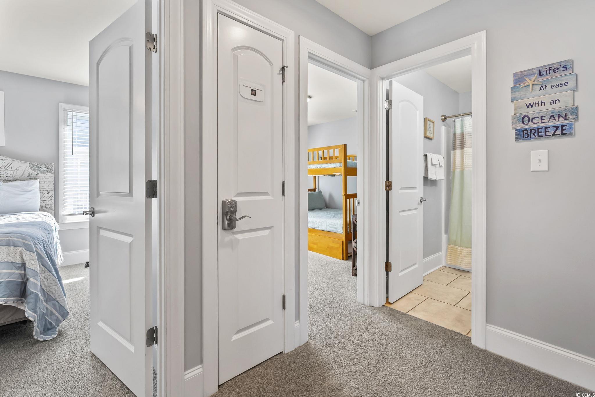 7401 North Ocean Boulevard, Unit 5 Myrtle Beach, SC 29572 - Photo 20 of 34 Hall featuring plenty of natural light and light carpet