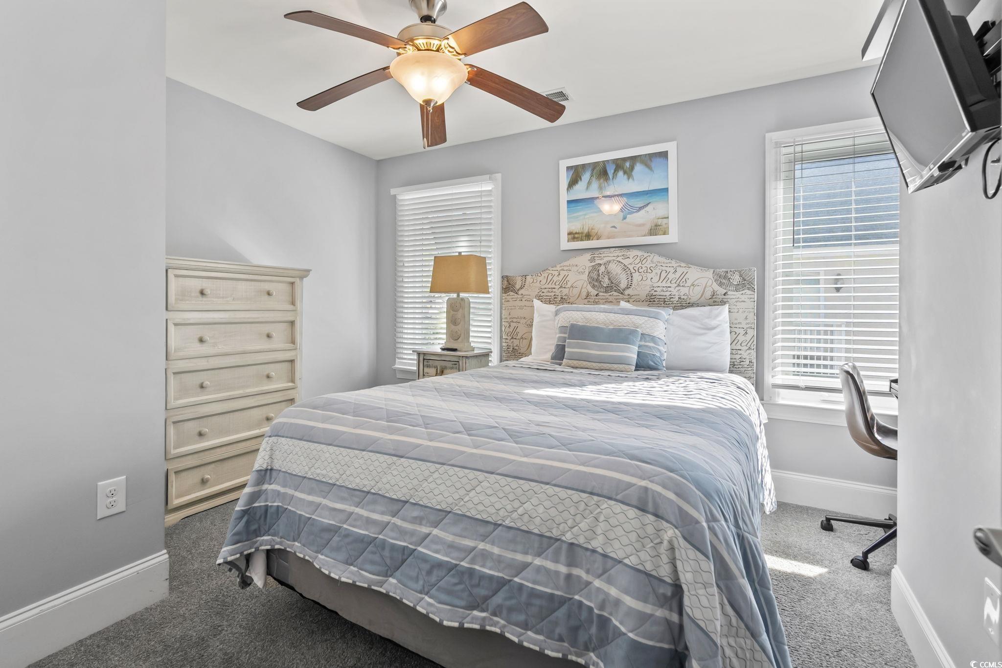 7401 North Ocean Boulevard, Unit 5 Myrtle Beach, SC 29572 - Photo 21 of 34 Bedroom featuring carpet flooring and a ceiling fan
