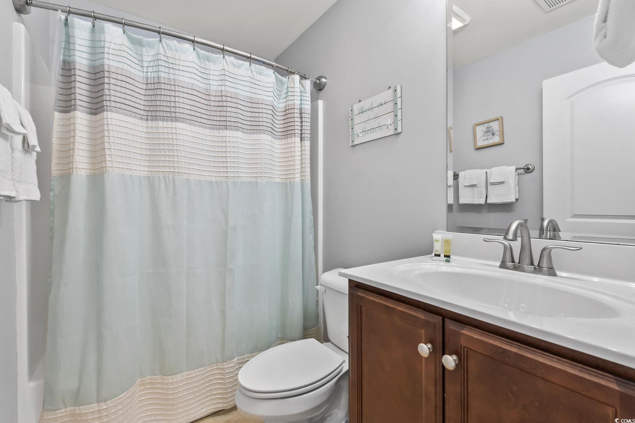 7401 North Ocean Boulevard, Unit 5 Myrtle Beach, SC 29572 - Photo 23 of 34 Bathroom featuring vanity and shower / tub combo