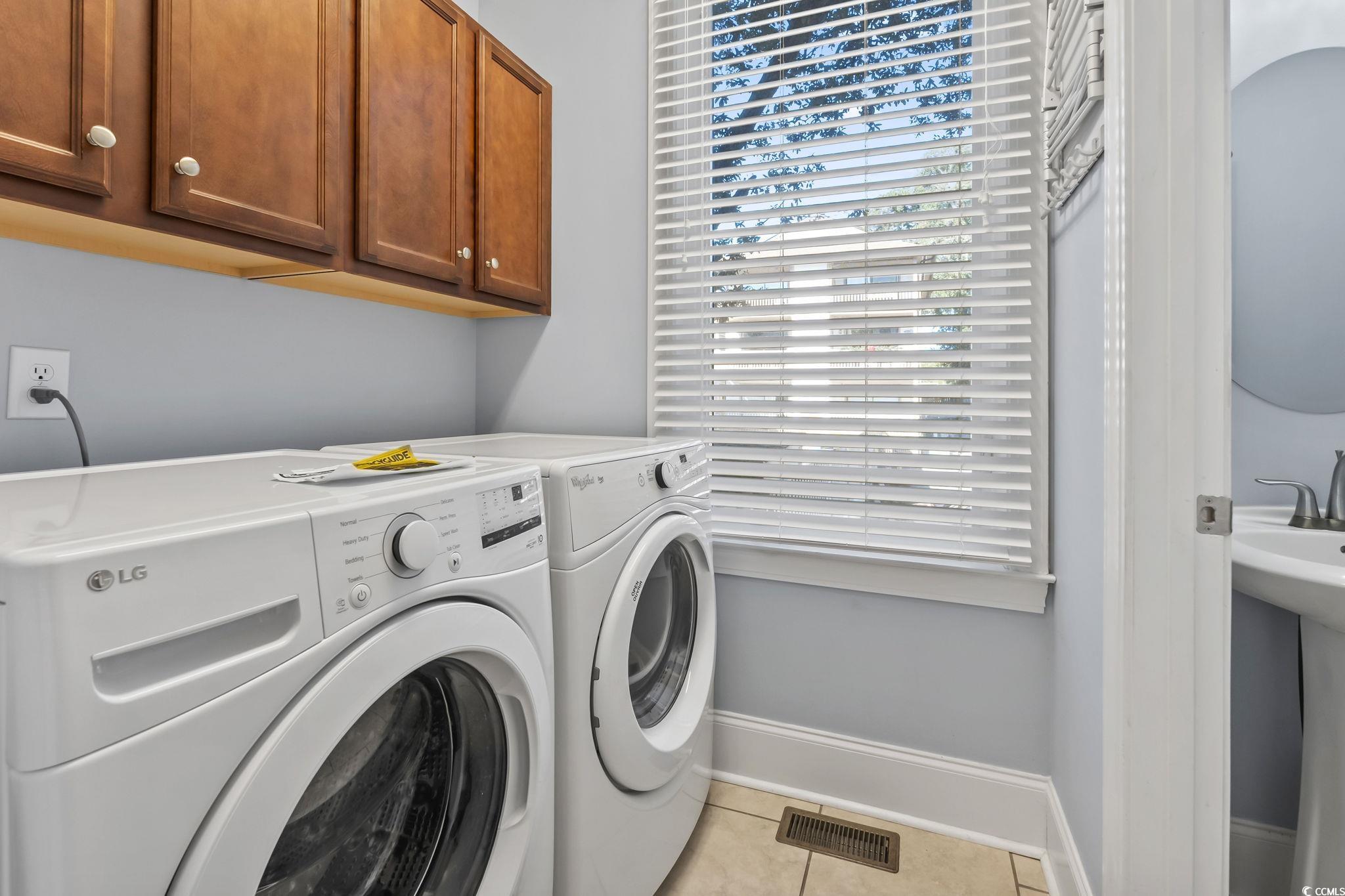 7401 North Ocean Boulevard, Unit 5 Myrtle Beach, SC 29572 - Photo 24 of 34 Laundry room featuring light tile patterned floors, cabinet space, and independent washer and dryer