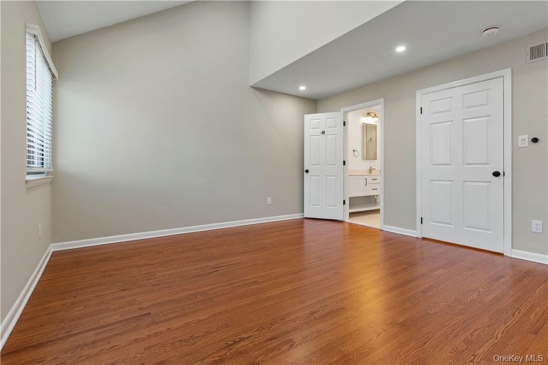 50 Pondview Road, Unit F Rye, NY 10580 - Photo 14 of 25 a view of empty room with wooden floor and window