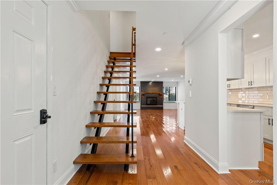 50 Pondview Road, Unit F Rye, NY 10580 - Photo 2 of 25 a view of entryway and kitchen with wooden floor