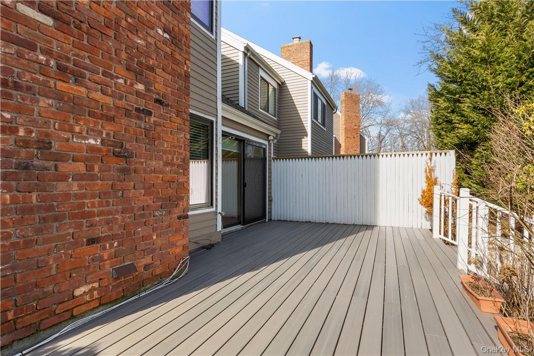 50 Pondview Road, Unit F Rye, NY 10580 - Photo 22 of 25 a view of backyard with a deck and wooden floor