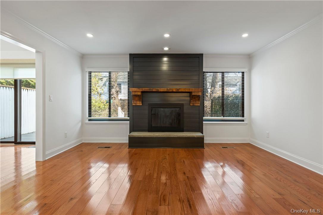 50 Pondview Road, Unit F Rye, NY 10580 - Photo 7 of 25 a view of empty room with wooden floor and fireplace