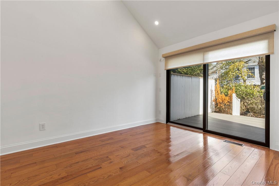 50 Pondview Road, Unit F Rye, NY 10580 - Photo 9 of 25 a view of an empty room with wooden floor and a window