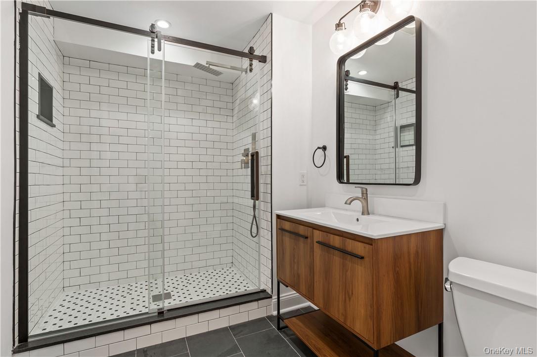 50 Pondview Road, Unit F Rye, NY 10580 - Photo 10 of 25 a bathroom with a shower toilet and sink