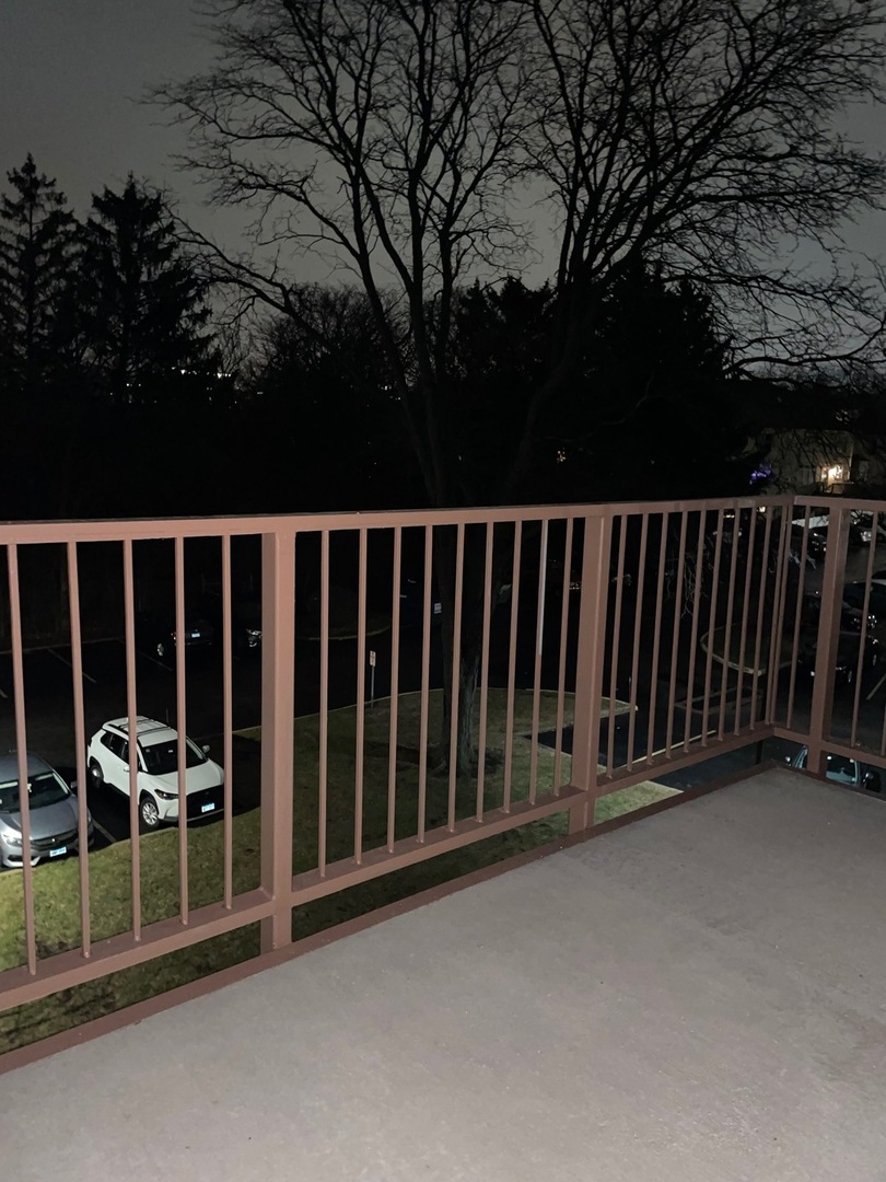 430 Walnut Creek Road, Unit 2306 Lisle, IL 60532 - Photo 11 of 14 a view of a roof deck with wooden fence and floor