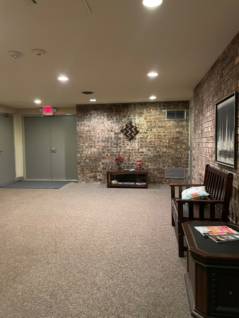 430 Walnut Creek Road, Unit 2306 Lisle, IL 60532 - Photo 13 of 14 a living room with furniture and a flat screen tv