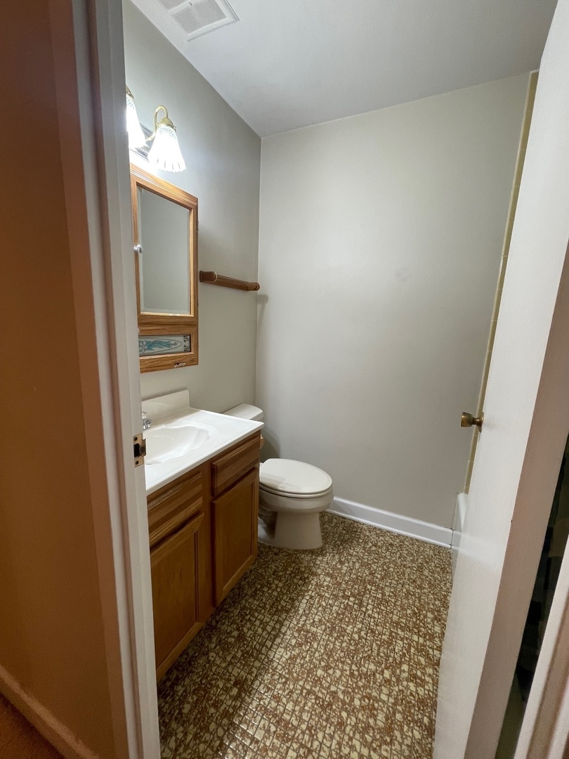 430 Walnut Creek Road, Unit 2306 Lisle, IL 60532 - Photo 3 of 14 a bathroom with a sink and a toilet