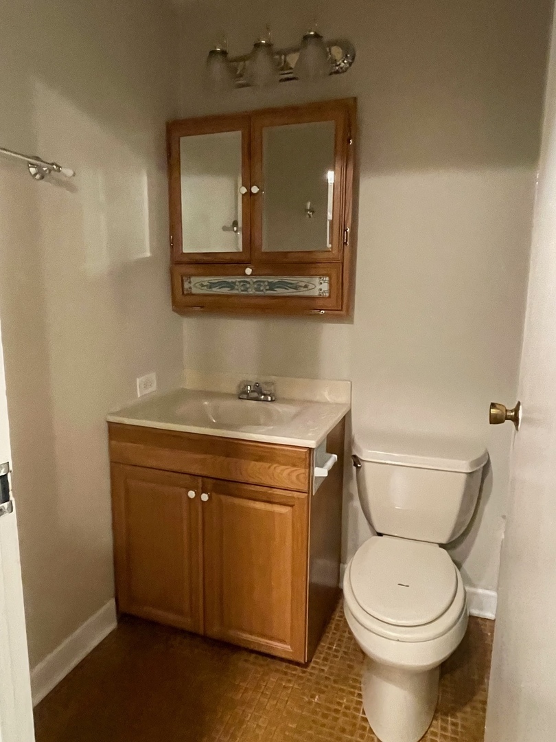 430 Walnut Creek Road, Unit 2306 Lisle, IL 60532 - Photo 7 of 14 a bathroom with a toilet and a sink