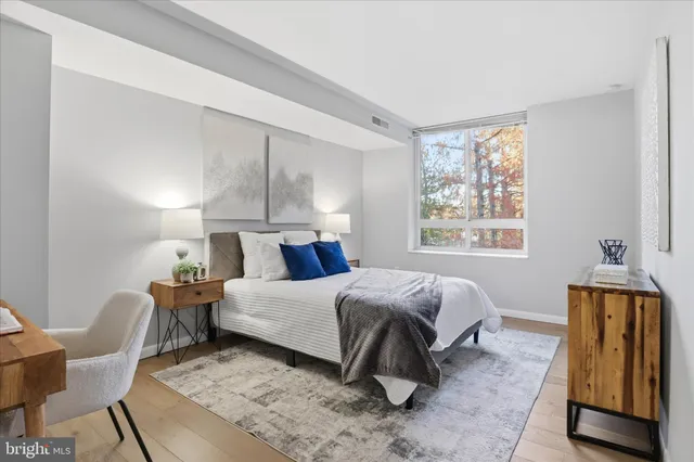 a bed room with a bed and chair