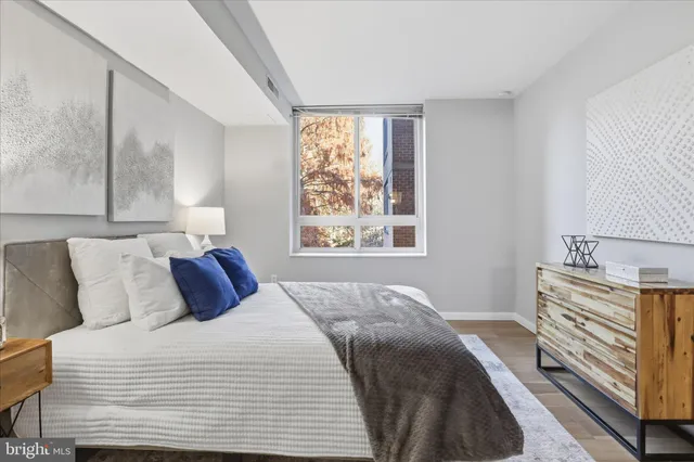 a bedroom with a bed and a window