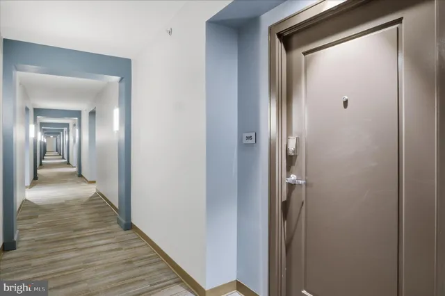 a view of a hallway with wooden floor