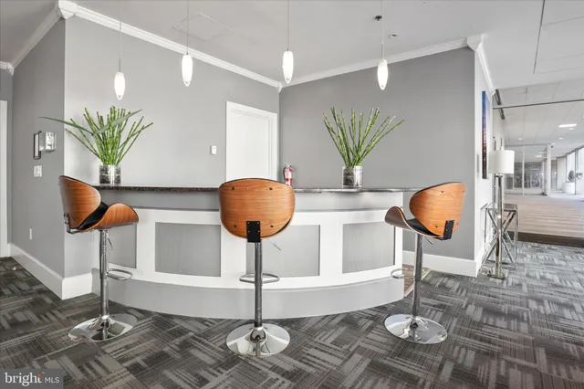 a living room with a table and chairs