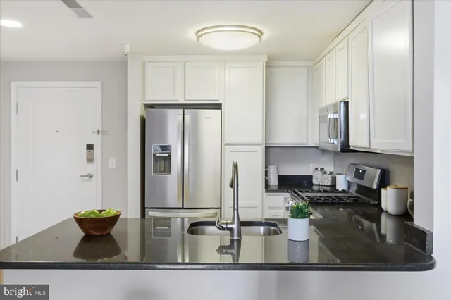 a kitchen with sink and stainless steel appliances