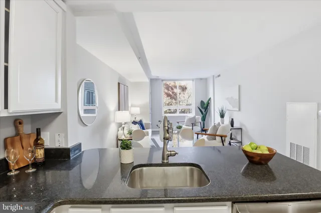 a kitchen with a granite countertop sink and a granite counter top