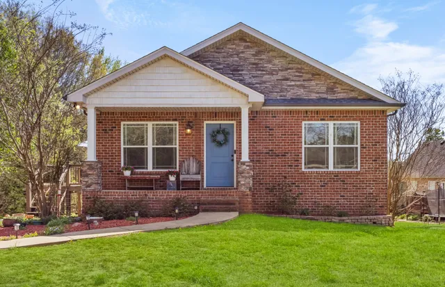 a front view of a house with a yard and porch