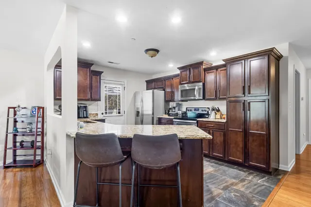 a kitchen with refrigerator cabinets dining table and chairs