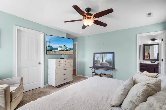 a bedroom with furniture and a large window