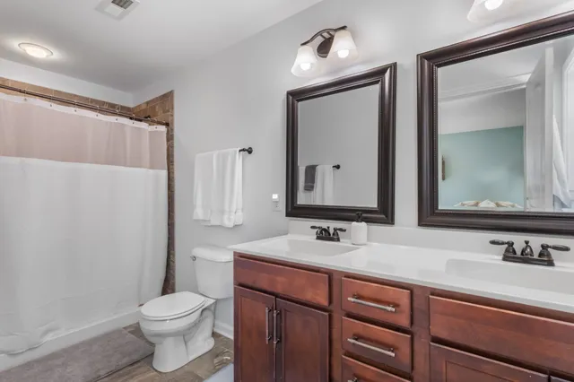 a bathroom with a double vanity sink and a mirror