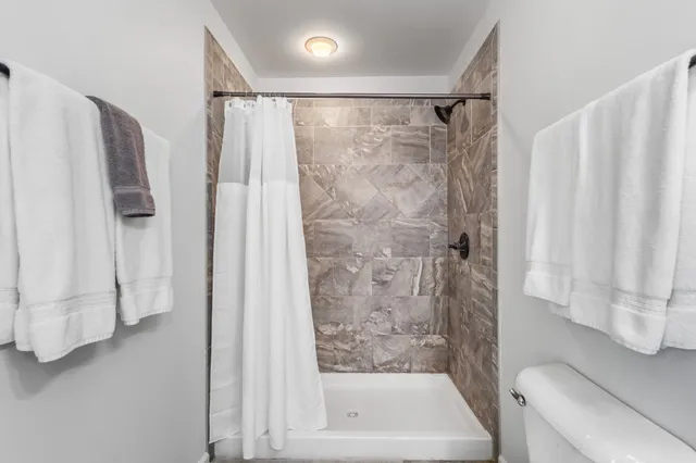 a bathroom with a shower curtain and a bathtub