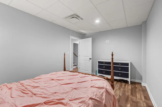 a bedroom with a bed and a dresser