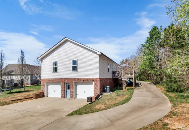 a view of a house with a backyard