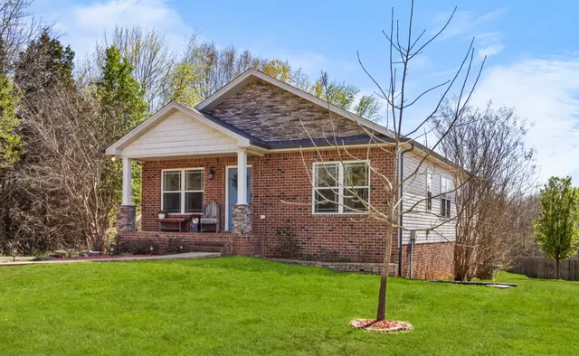 a front view of house with a garden and patio
