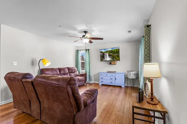 a living room with furniture and wooden floor