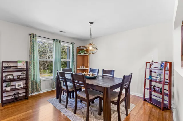 a dining room with furniture and wooden floor