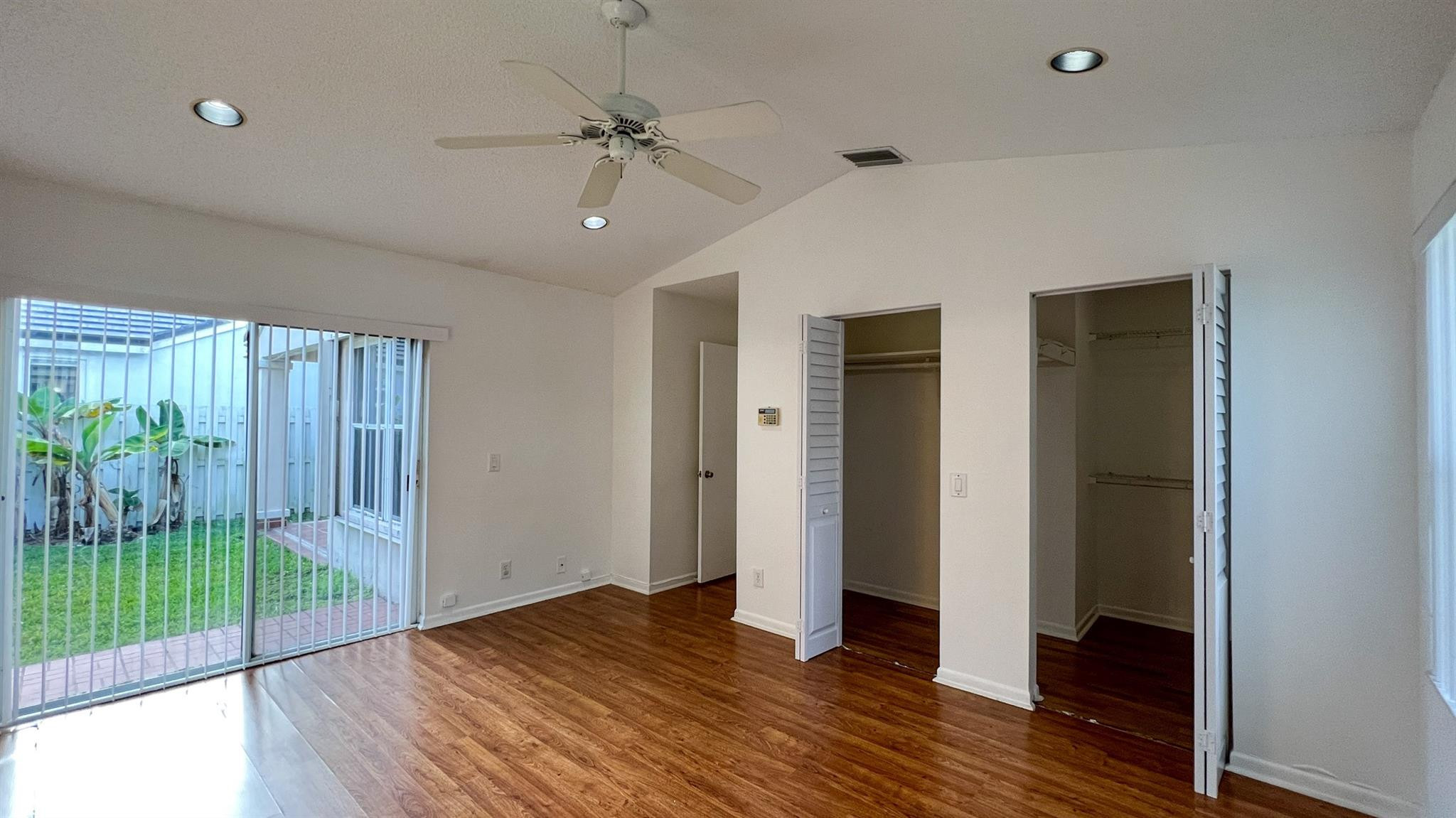 670 Falling Water Road Weston, FL 33326 - Photo 14 of 17 a view of an empty room with wooden floor and a window