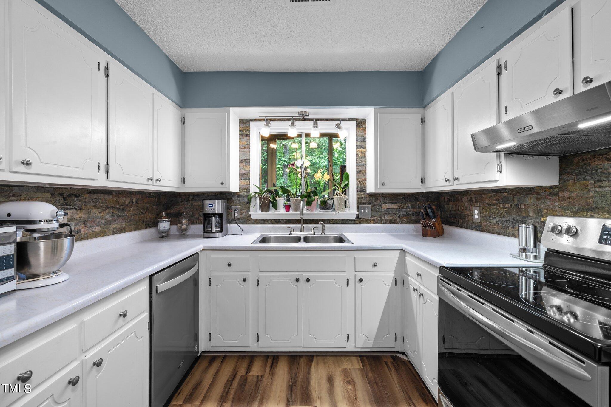 1917 Front Street, Unit 4C Durham, NC 27705 - Photo 23 of 53 a kitchen with a sink stove and cabinets